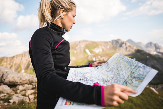Adventurous mountain girl surrounded by beautiful mountains
