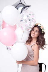 Smiling beautiful woman having fun with balloons.