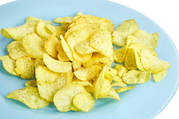 Potato chips on blue plate. Isolated  on white background