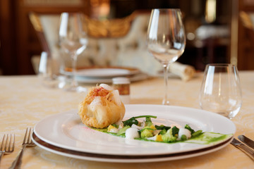 Creative fish dish in classic restaurant