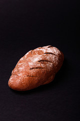 Homemade dark bread isolated on black background