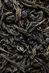 Black tea loose dried leaves. Background
