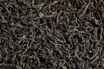 Black tea loose dried leaves. Background