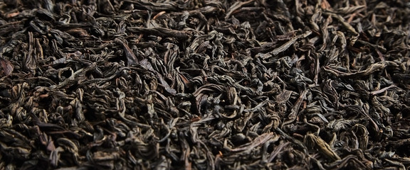 Black tea loose dried leaves. Background