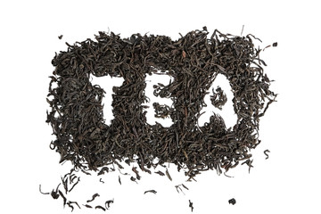 Dry black tea leaves. Isolated on white background. Inscription, word tea