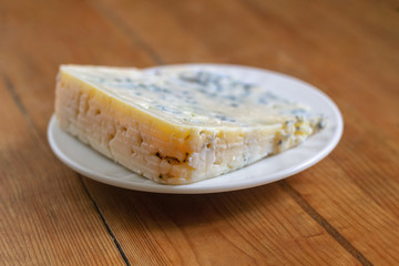 Cheese with a mold in a white plate