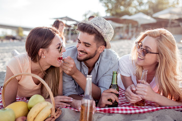 Happy people drinking beer on the beach