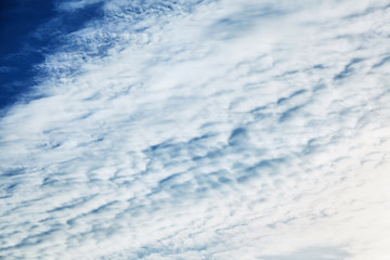 The blue sky with clouds, background