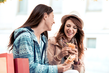 Young attractive women are enjoying outdoors after shopping