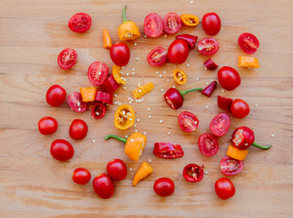 cut chilli peppers and tomatoes on wooden table. Above view