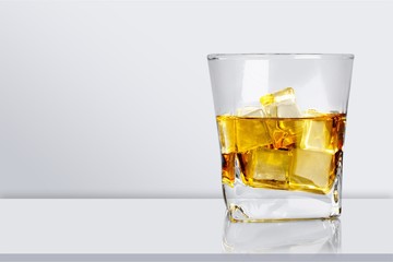 Glass of tasty cocktail on desk