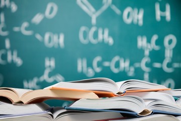 Heap of open books at school room