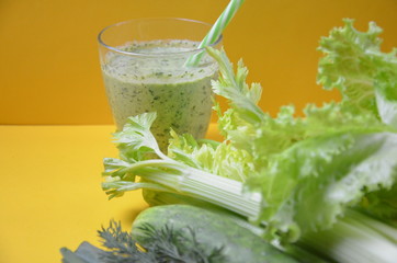 Healthy green smoothie and ingredients on yellow - superfoods, detox, diet, health, vegetarian...