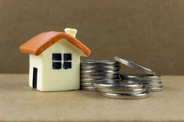 little house near a pile of coins