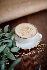 Cappuccino with nuts on the table.