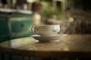 An old cup of tea on the table.