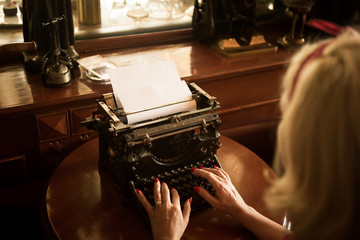 She's a writer and writes a book on a typewriter in the past century.