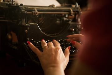 Naklejka na ściany i meble Copywriter hands on a typewriter.