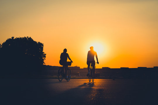 couple /  two people riding bicycle  
