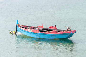 Naklejka na ściany i meble wooden fishing boat anchored