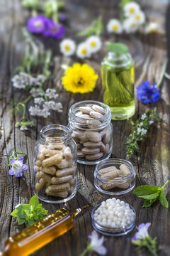 alternative herbal medicine. herbal vitamin on ols wooden board background.