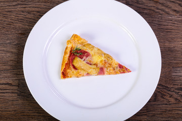 Pizza with ham and sausages