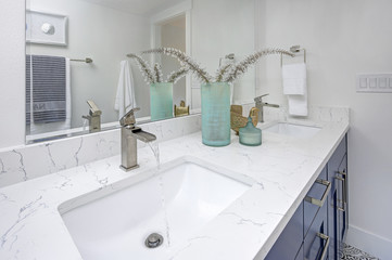 Chic master bathroom with marble-top vanity.