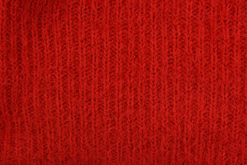 Texture of weaving, Handmade knitted texture of fiber, backdrop, thread. warm red plaid background. Closeup of pullover sweater