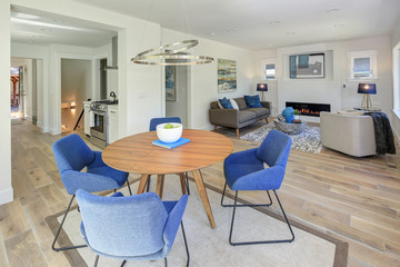 Modern dining room with wood table and blue chairs.