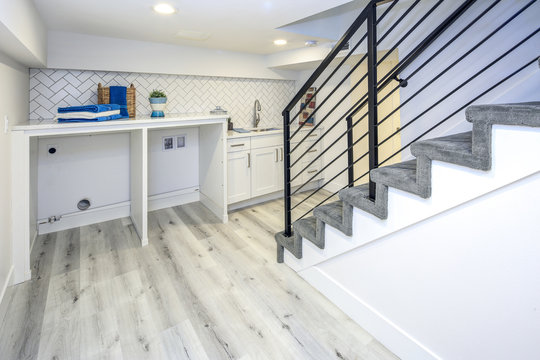 Basement laundry room interior with a sink.