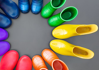 Colorful rubber boots of all colors of the rainbow-red, orange, yellow, green, blue, cyan and...