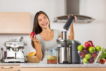 Vegetable juice healthy food juicer machine- Asian woman juicing green and red apple fruits as part...