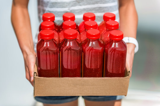 Beet Juice Red Smoothie Juicing Bottles Box Of Cold Pressed Vegetable Juices. Woman Holding Delivery Box. Health Trend For Cleansing Of Organic Raw Juices. Juicing For Diet Cleansing Detox.