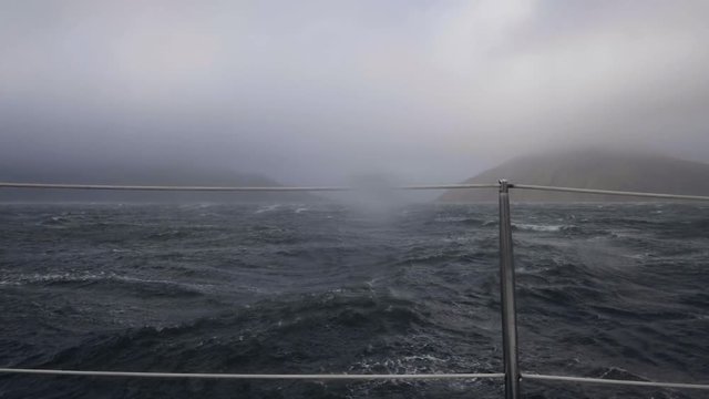 Sailing ship swinging on stormy sea waves view from board. Cruise ship in storm