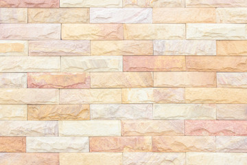 Cream and white brick wall texture background. Brickwork or stonework flooring interior rock old pattern clean concrete grid uneven bricks design stack.