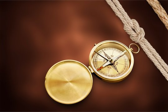 Brass antique compass on desk