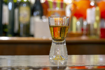 Glass of whiskey on a stone bar counter