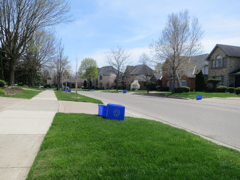 Recycling day garbage containers in front yards