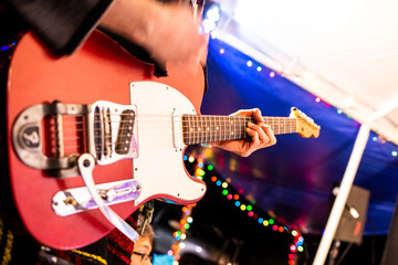 Obraz na płótnie Canvas Artist playing electric guitar on the stage