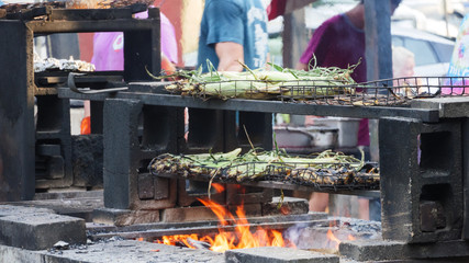 corn on the cob roasting on fire