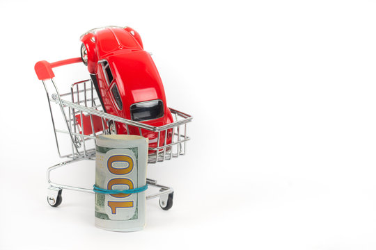 red car in shopping trolley with cash money