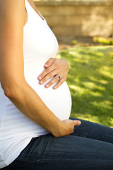 Happy pregnant woman outside in nature.