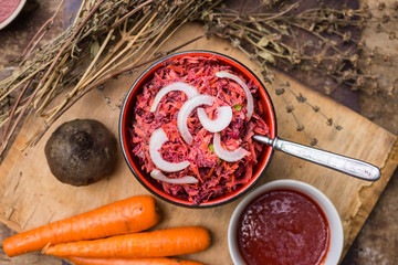 Vegetables pkhali served as salad in a bowl. Grated beetroot and cooked carrot with walnuts and onion. Georgian traditional food snack appetizer. Vegan vegetarian healthy food.