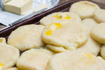 Cooked khachapuri bread with suluguni cheese and butter. Georgian traditional food.