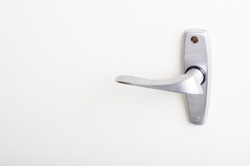 Metal handle on white door.