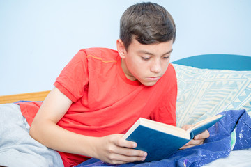 Teenage boy reading a book