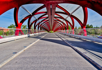 Internal view of a architecturally abstract bridge over a river 