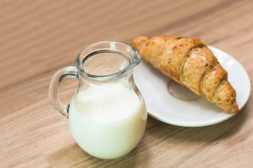 Fresh homemade milk pot and croissant in breakfast.Copy space.