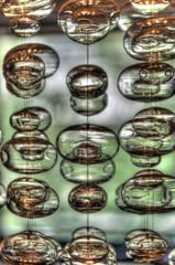 blown glass bubble orbs suspended by string in a foyer