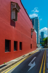 Red wall and three windows frame with white antique window in the narrow alley
